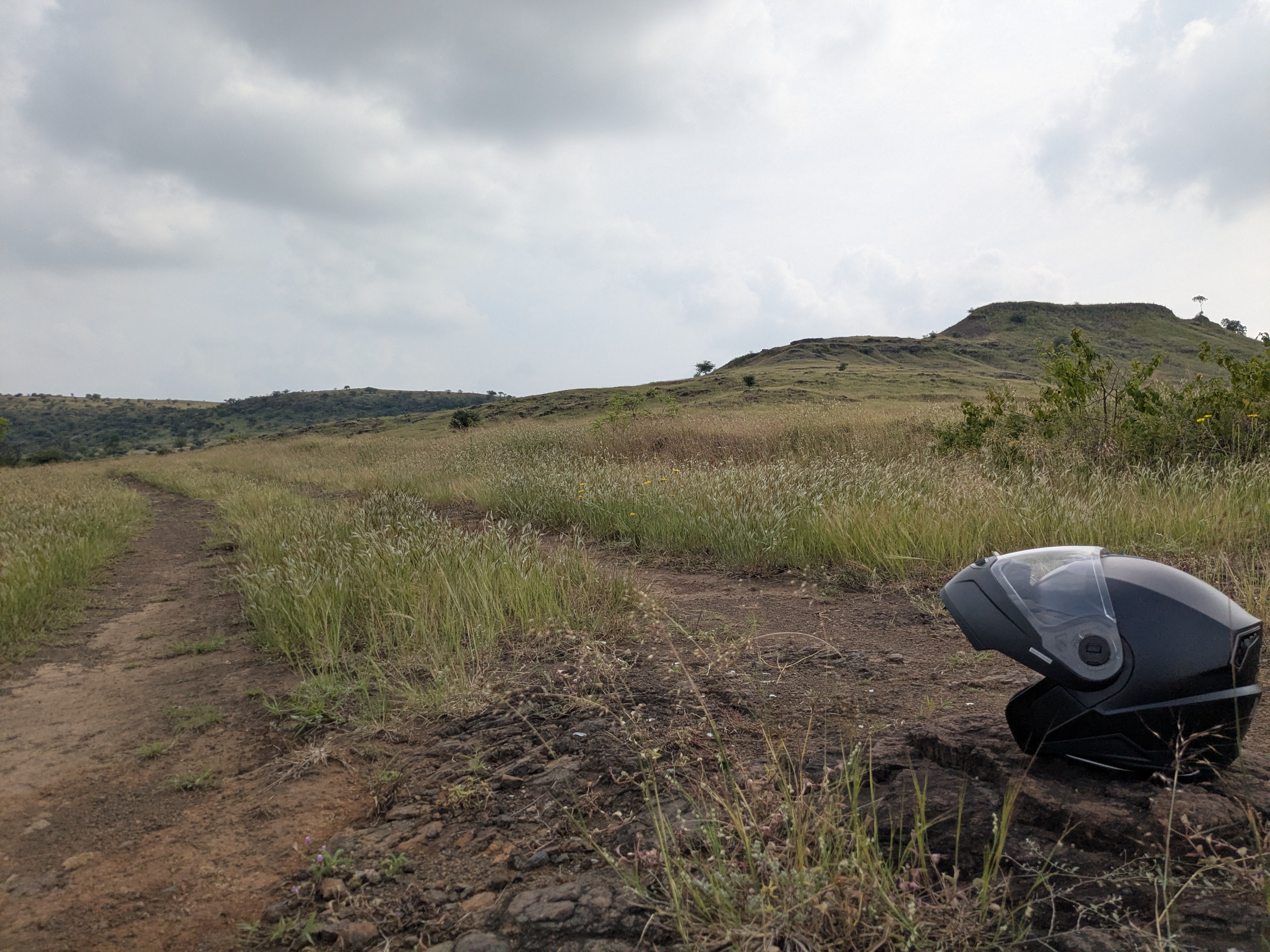 Helmet on a small rock in a grassland